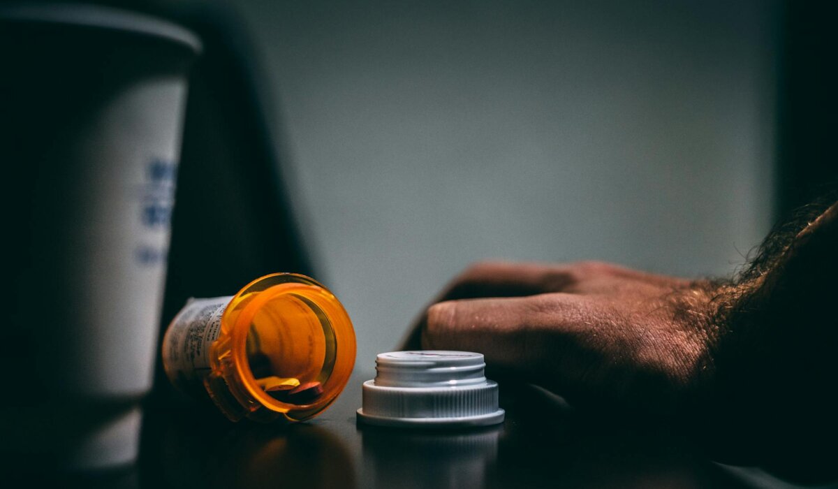 orange and white prescription bottle on table