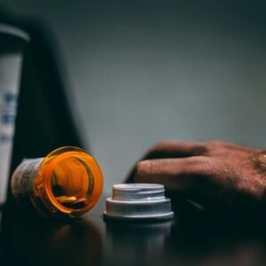 orange and white prescription bottle on table