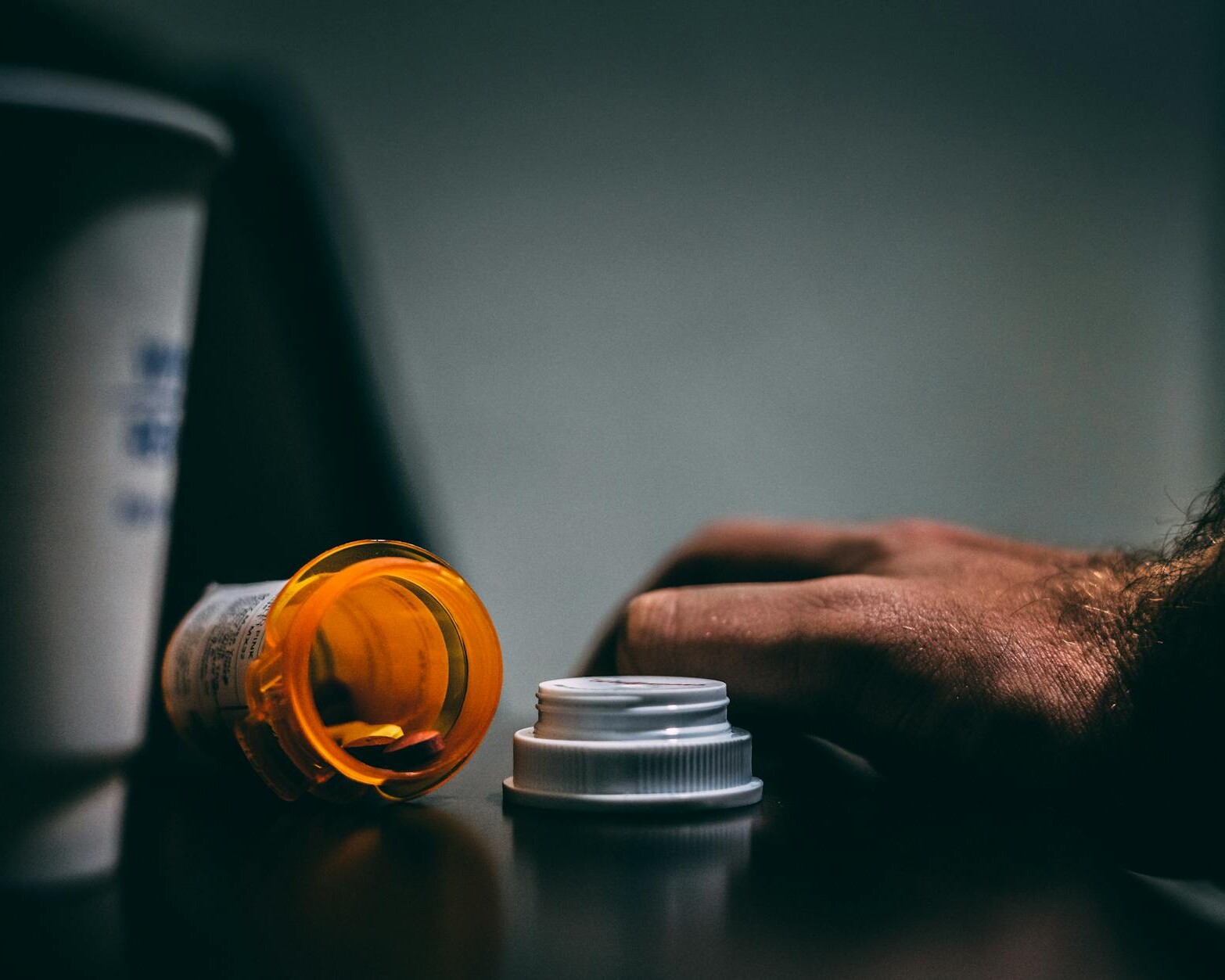 orange and white prescription bottle on table