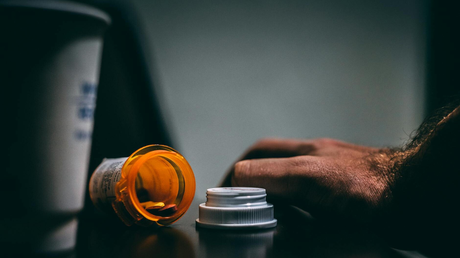 orange and white prescription bottle on table