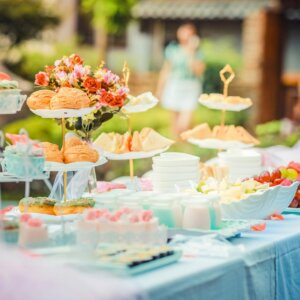 various desserts on a table covered with baby blue cover