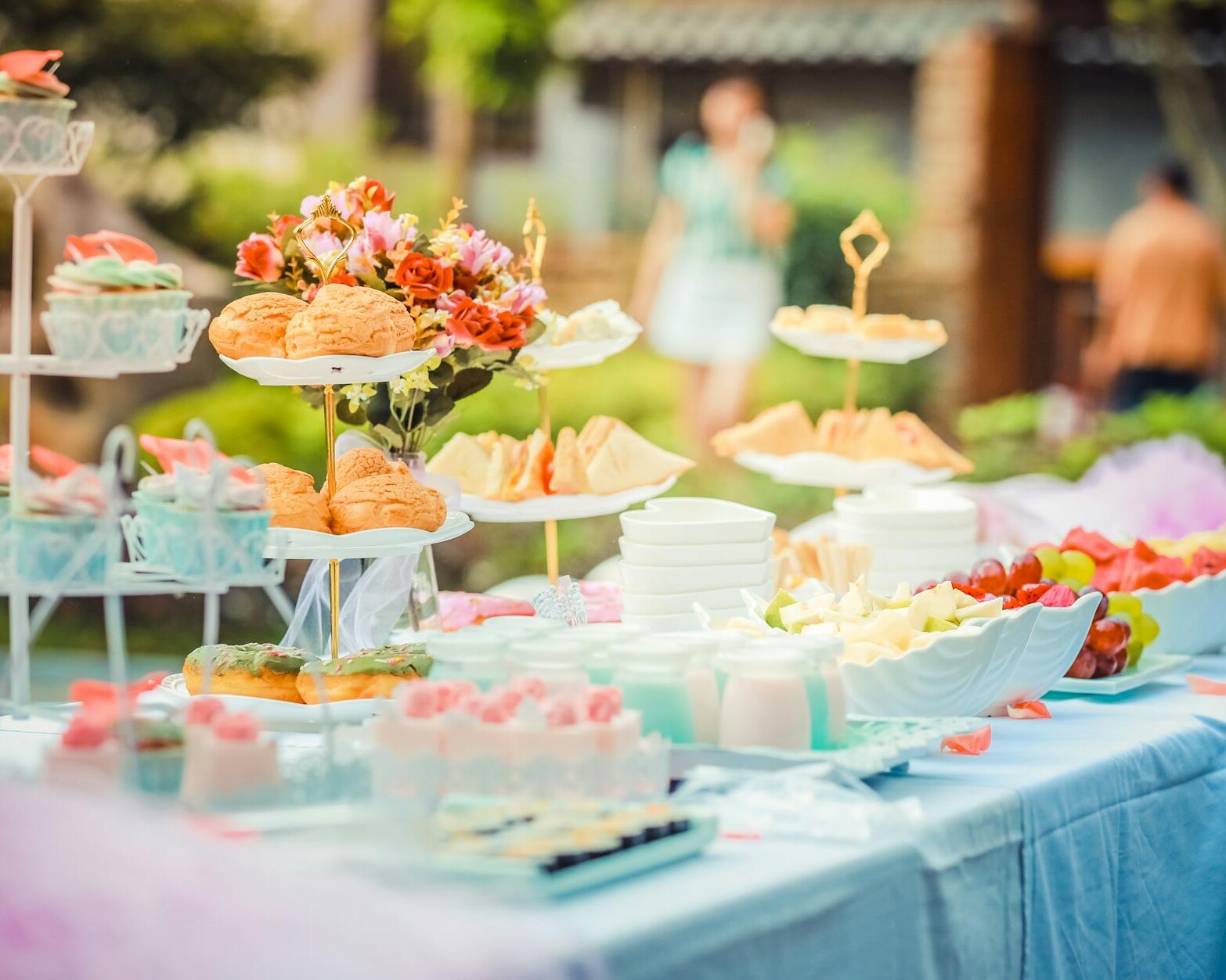 various desserts on a table covered with baby blue cover