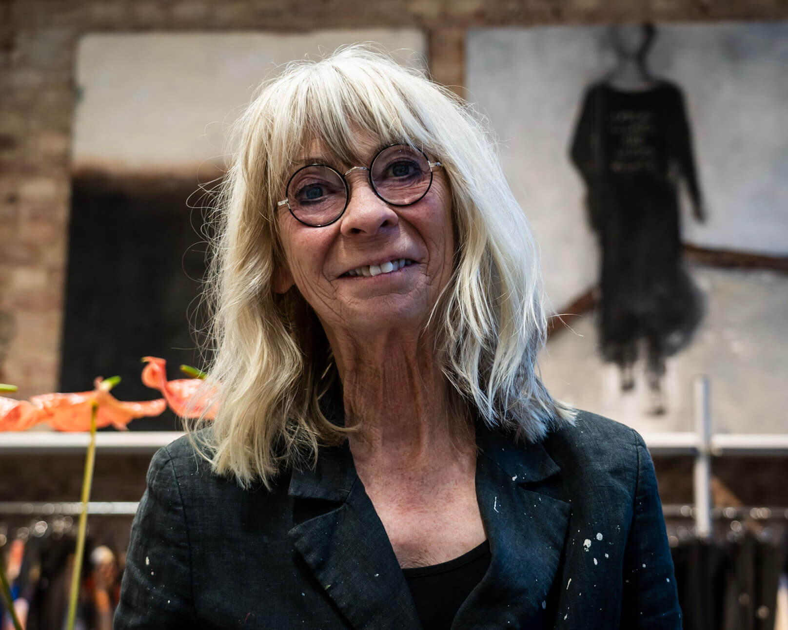 Susy Grundahl foran et par af de udstillede malerier hos Marie Lahn. Foto: Fjodor Pedersen.