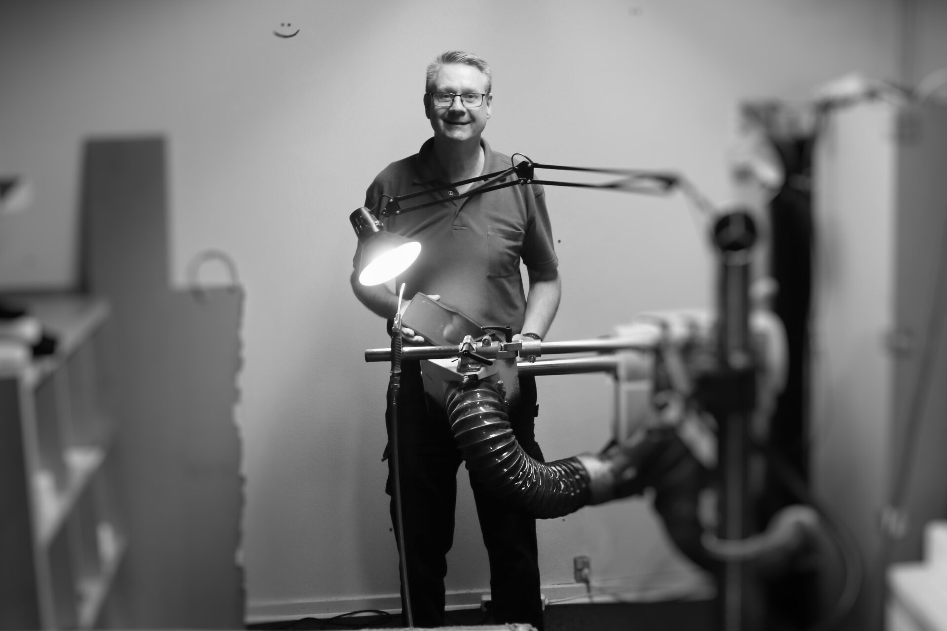 Andreas ved slibemaskinen, hvor sålerne rettes til. Foto: Johnny Tauman.