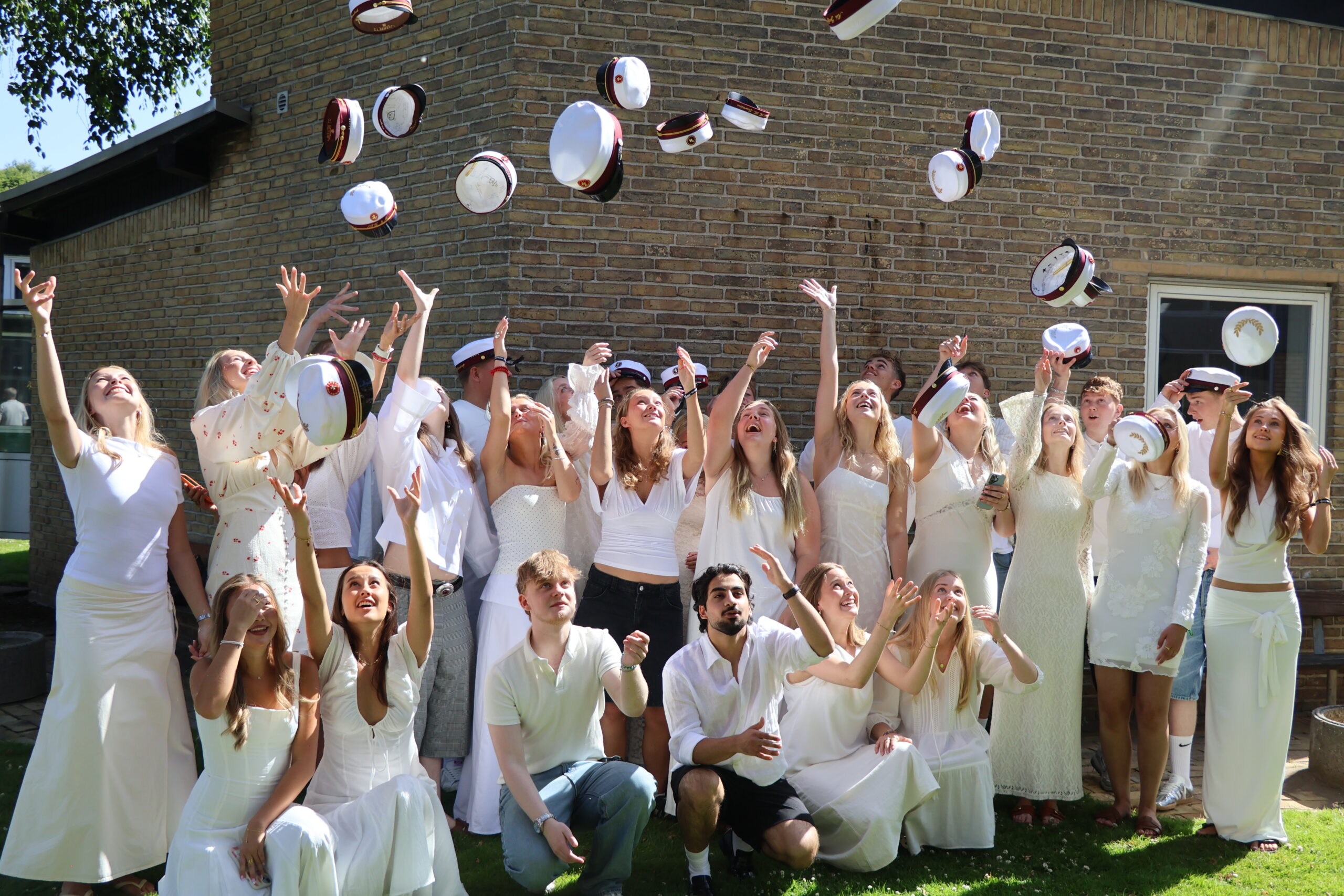 Traditionen tro blev studenterhuerne kastet mod sommerhimlen, da dimissionen var vel overstået. Foto: Rybners.
